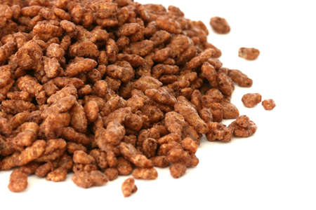 Chocolate popped rice cereals scattered on white backgroundの写真素材