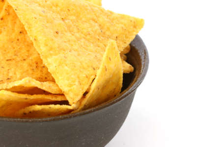 Mexican tortilla chips in brown bowl on white backgroundの写真素材