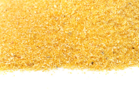 Yellow corn flour scattered on white backgroundの写真素材