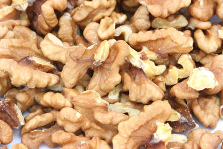 Halves of walnuts on scattered white backgroundの写真素材