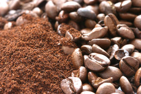 Whole and ground coffee beans scatteredの写真素材