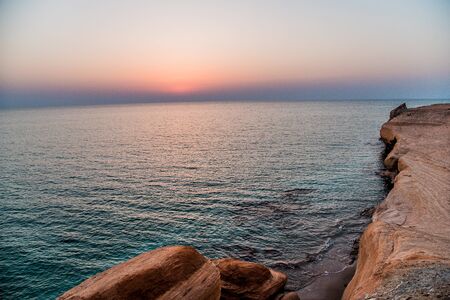 rocky seashore sunset, Shuweihat islandの写真素材
