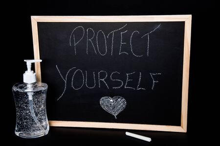 Protect yourself, clear gel hydroalcoholic bottle, sanitizerの写真素材