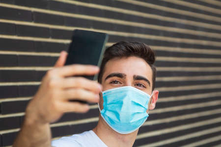 Man with mask taking a selfie.の写真素材