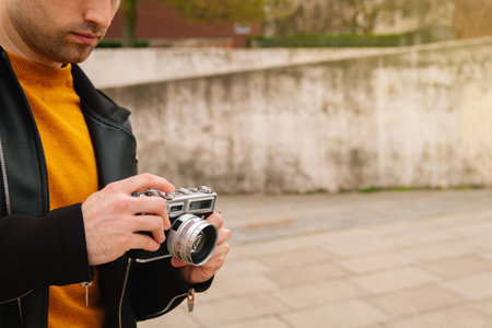 Young Hispanic tourist, taking pictures outdoors during his vacations or his honeymoon. lifestyle...