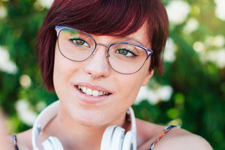 Close-up of the face of a beautiful woman with glasses and pretty green eyes