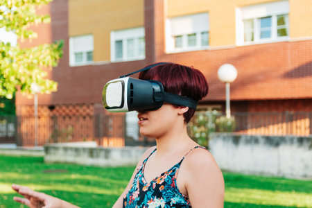 Young woman with virtual reality glasses in a city field. digitization conceptの写真素材