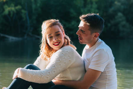 Happy couple in love celebrating Valentine's Day in a romantic atmosphere. Concept of hug, kiss, passion, tenderness and freedomの写真素材