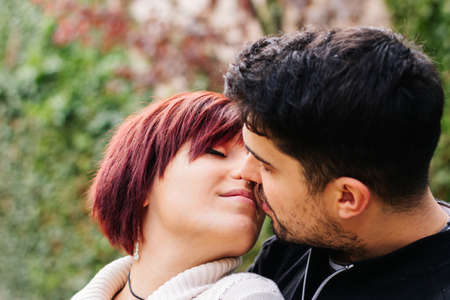 Two loving people 20-29 years old, kissing outdoors on Valentine's Day.の写真素材