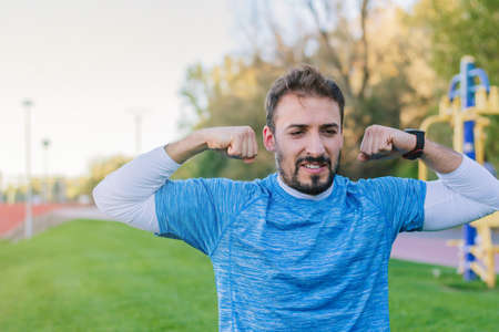 30 year old adult man showing his sports progress to his presonal coach during an online training. Concept of overcoming, attitude, strength, overcoming, strength and healthy outdoor life.の写真素材