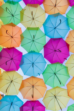 Street decorated with colored umbrellas. Sky covered by colored decorations at parties. AgÃ¼eda, Portugalの写真素材