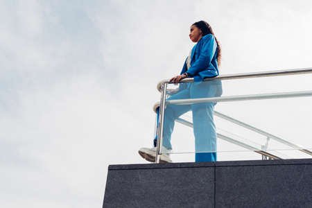 Young businesswoman, on top of a skyscraper looking at the horizon. Concept of feminism, success, strength, businesswoman, new generations, tenacity and courage. copy spaceの写真素材