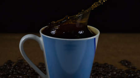 Cup and drops of coffeeの写真素材