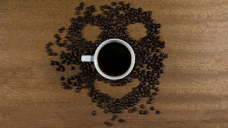 Face with coffee beans and cup of coffeeの写真素材