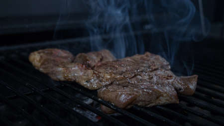 Cook making charcoal roast meatの写真素材
