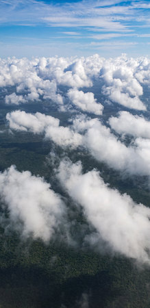 Aerial view of clouds over green areasの写真素材