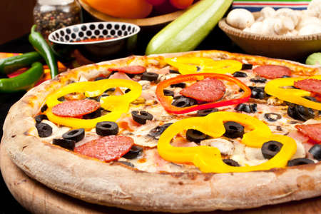 Tasty pizza and fresh vegetablesの写真素材