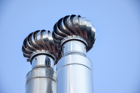 Two metal chimneys whit ventilationの写真素材