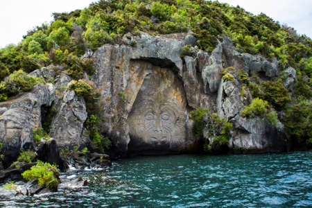 Travel New Zealand, North Island, Taupo. Cruise view of Iconic Maori rock carving in the rock on Great Lake Taupo. Popular tourist attraction/activity.の写真素材