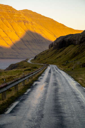 Scenic view of road while sunset in Stroymoy Island, Faroe Islandsの写真素材