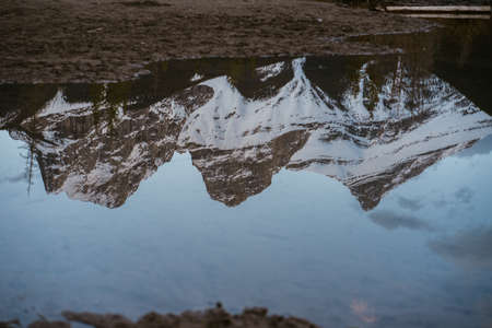 Breathtaking view of the iconic Three Sisters mountain peaks reflection in Policeman's Creek calm...