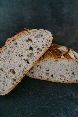 Close up or detailed view of freshly baked sourdough bread, dark background.の写真素材