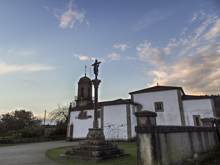 the church of San Salvador and the cruceiro that presides over its lateral and its accessの写真素材