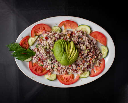 Shrimp and fish ceviche dish with avocado, tomato and onion, Mexican foodの写真素材