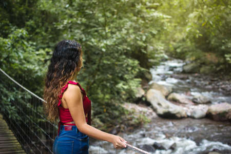 Woman in nature on a bridgeの写真素材