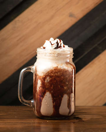 Sweet chocolate frappe with whipped cream served in long glass.の写真素材