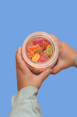 Gummy Bear in the hands of a childの写真素材