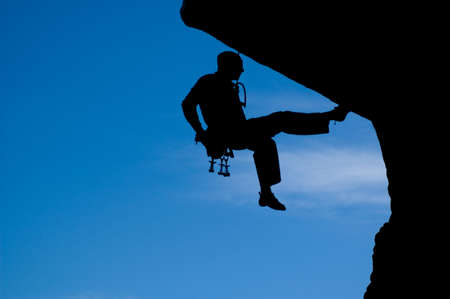 Rock climber climbing with a ropeの写真素材