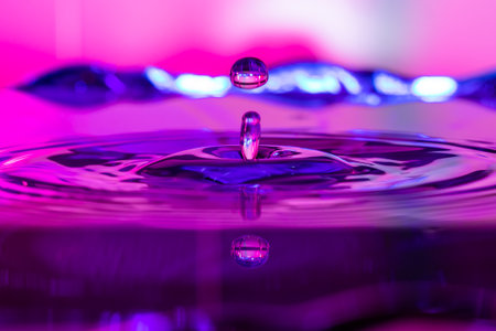 Water drop reflection in colors blues and pinkの写真素材
