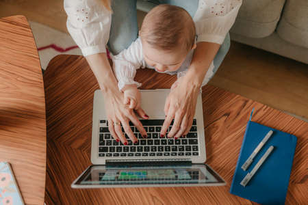 young business mother works from home with her cute babyの写真素材