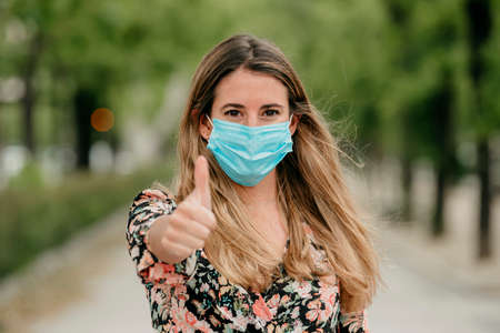 pretty girl on the street with medical maskの写真素材
