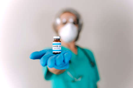 COVID-19 Coronavirus Vaccine. Doctor scientist analyzing virus Sars-CoV-2 in research for vaccine to...