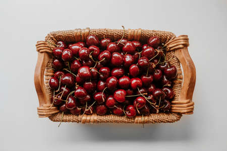 Cherries. Cherry. Cherries in wood bowl. Red cherry. Fresh cherries. Cherry on background. healthy food concept.の写真素材