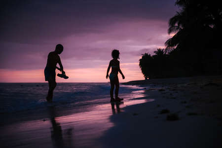 people enjoy the last hours of sunset on a coast of the philippinesの写真素材