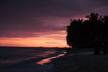 sunset on a beach in the philippines after a storm that leaves beautiful colorsの写真素材