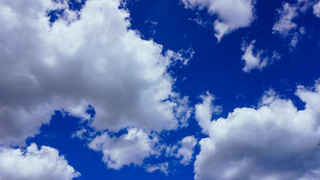White fluffy clouds on a bright blue sky