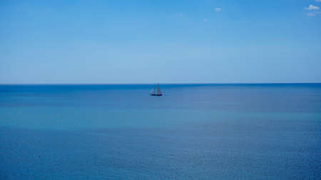 A single boat in the middle of the oceanの写真素材