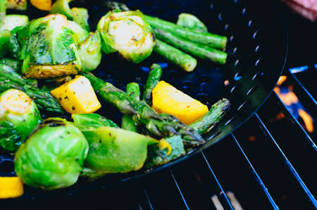 A grill pan with asparagus, zucchini, brussel sprouts and more.の写真素材