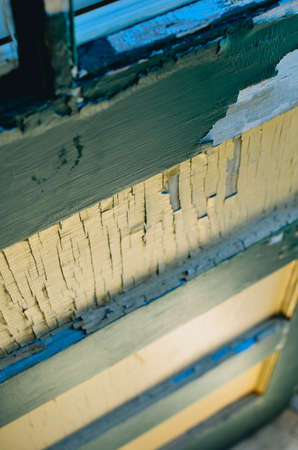 A green and white door with chipped paint. The angle of the photo is shot from above looking down.