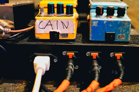 The power and cable end of a guitar pedalboard.