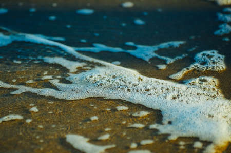 What ever the white stuff is called that foams up when the waves crash -- this is a close up of...