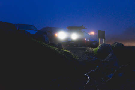 Car headlights on a foggy night