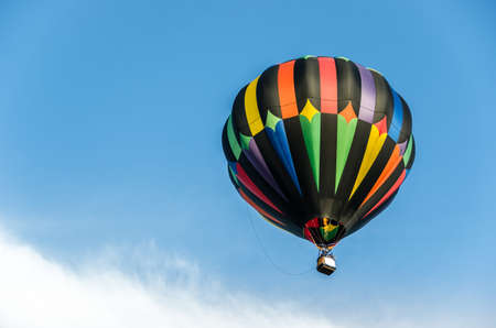 A Beautiful Hot Air Balloon In A Blue Sky With A Cloudの写真素材