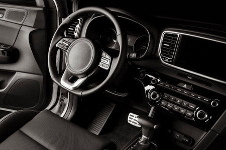 New car steering wheel, luxurious details in black leatherの写真素材