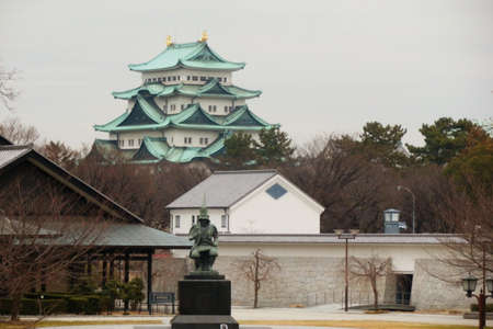Nagoya Castle in the background with a statue of the master Japanese castle architect Kato Kiyomasa のeditorial素材