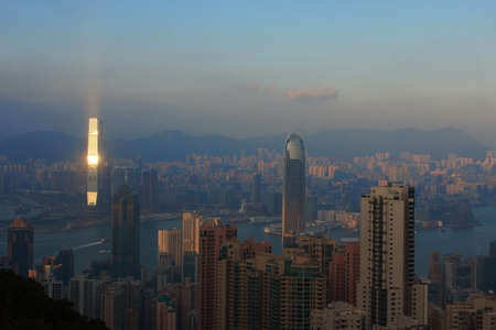 The setting Sun reflecting off The Hong Kong International Commerce Centre (ICC Tower)